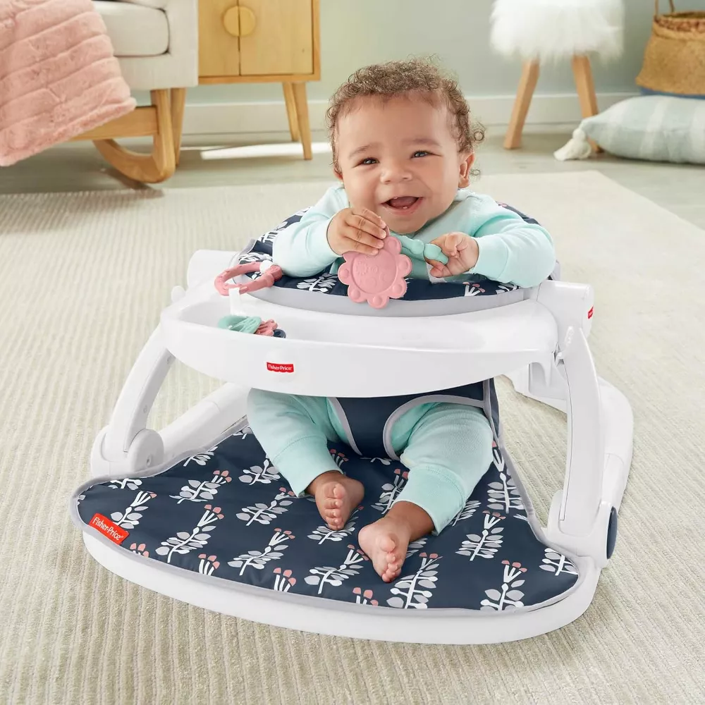 Fisher-Price Portable Baby Chair Sit-Me-Up Floor Seat With Snack Tray And Developmental Toys, Navy Garden. Easy to fold and lightweight, this seat is portable and ideal for both home use and on-the-go adventures. GMD19 thumbnail